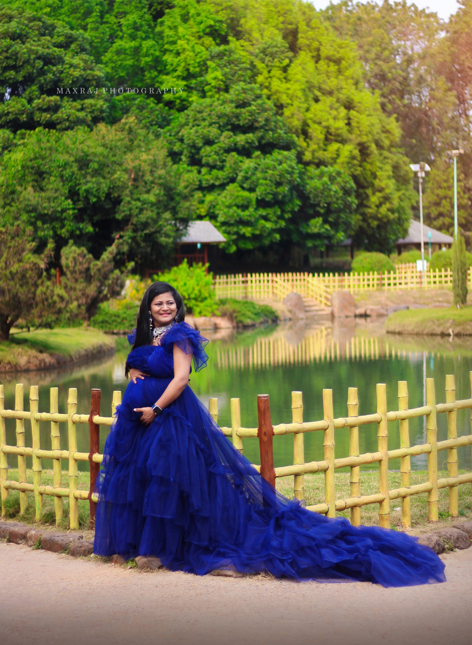 maternity photoshoot of a pregnant woman in pune in blue designer gown